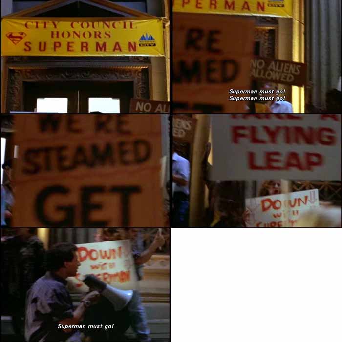 Protesters hold up anti-Superman signs at City Hall