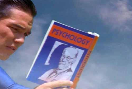 Superman reads Sigmund Freud book about psychology